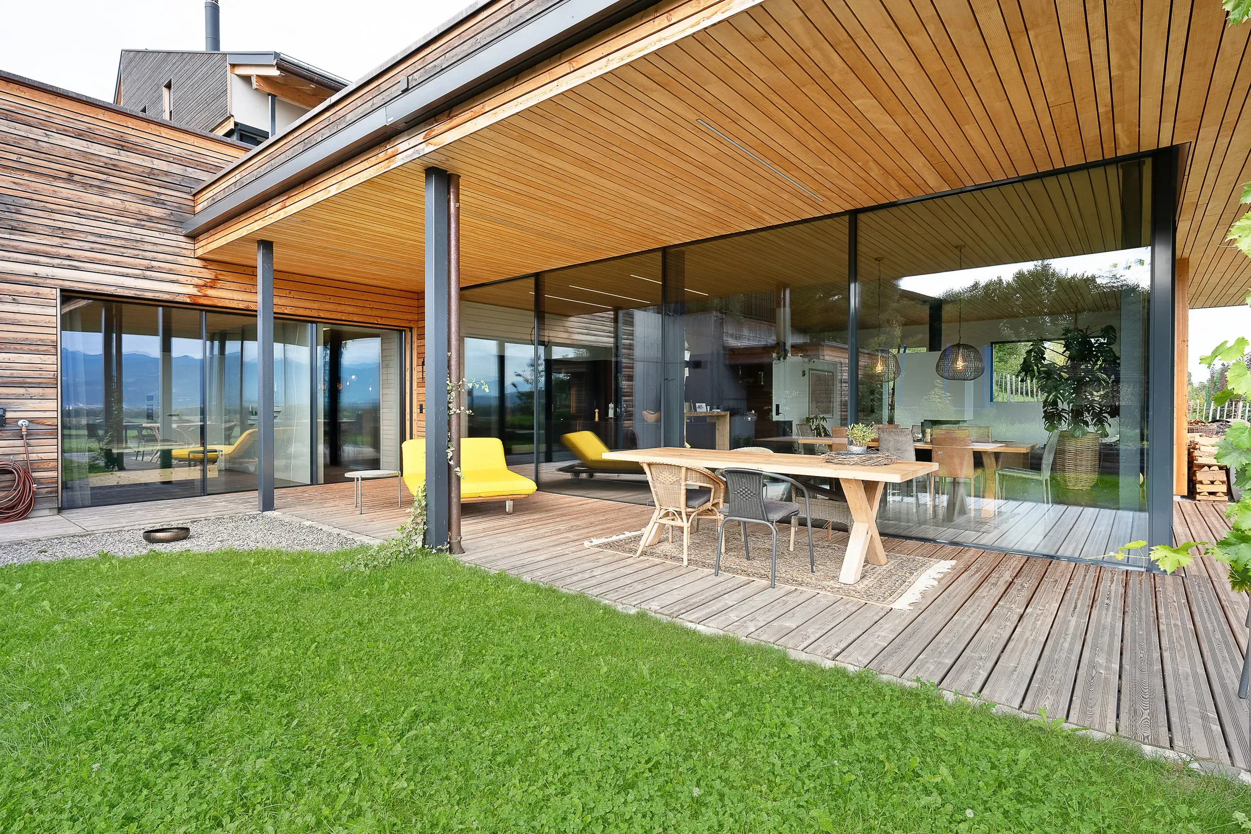 Sky-Frame-Verglasung mit Holzterrasse und Gartenperspektive — Einfamilienhaus Marbach
